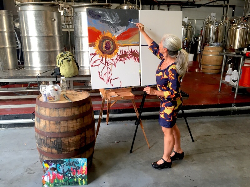 Artist Caroline Karp live painting at an event in Tampa.