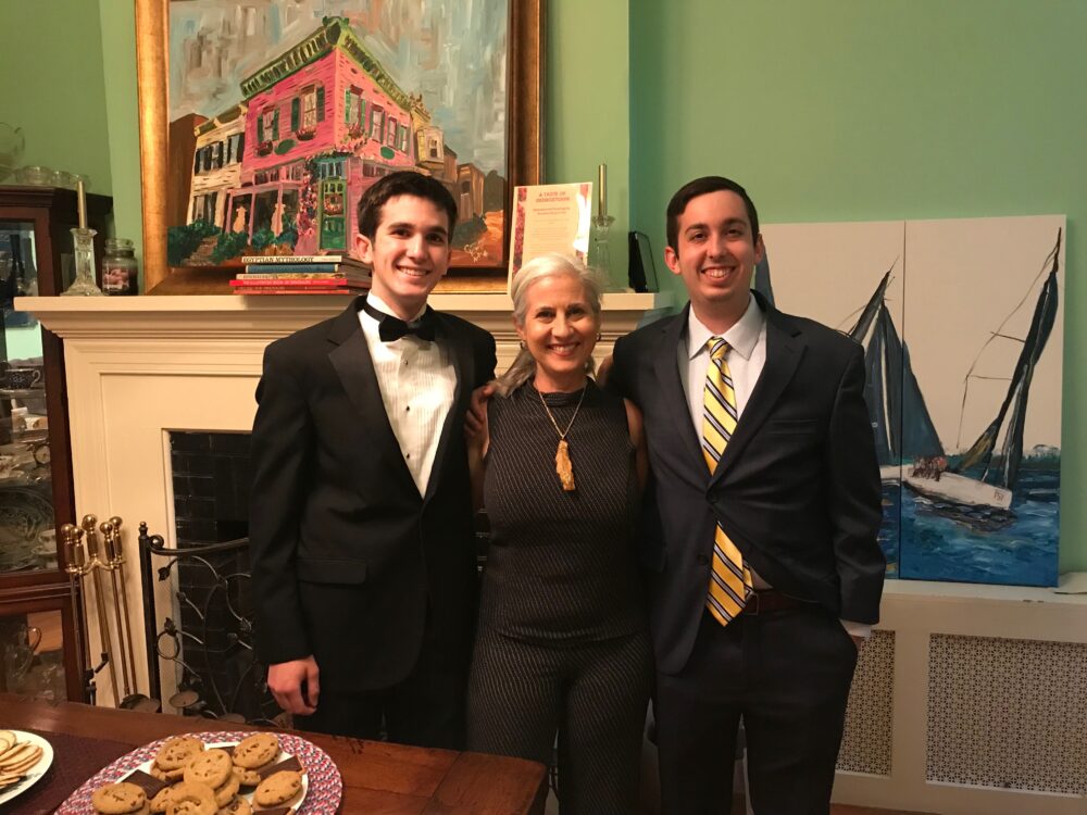 Artist Caroline Karp and her boys at her Georgetown art show