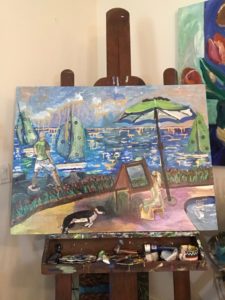 painting in progress showing the ocean, sailboats and people