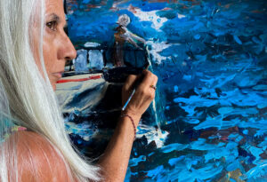 artist painting blue water with a lady in the boat.