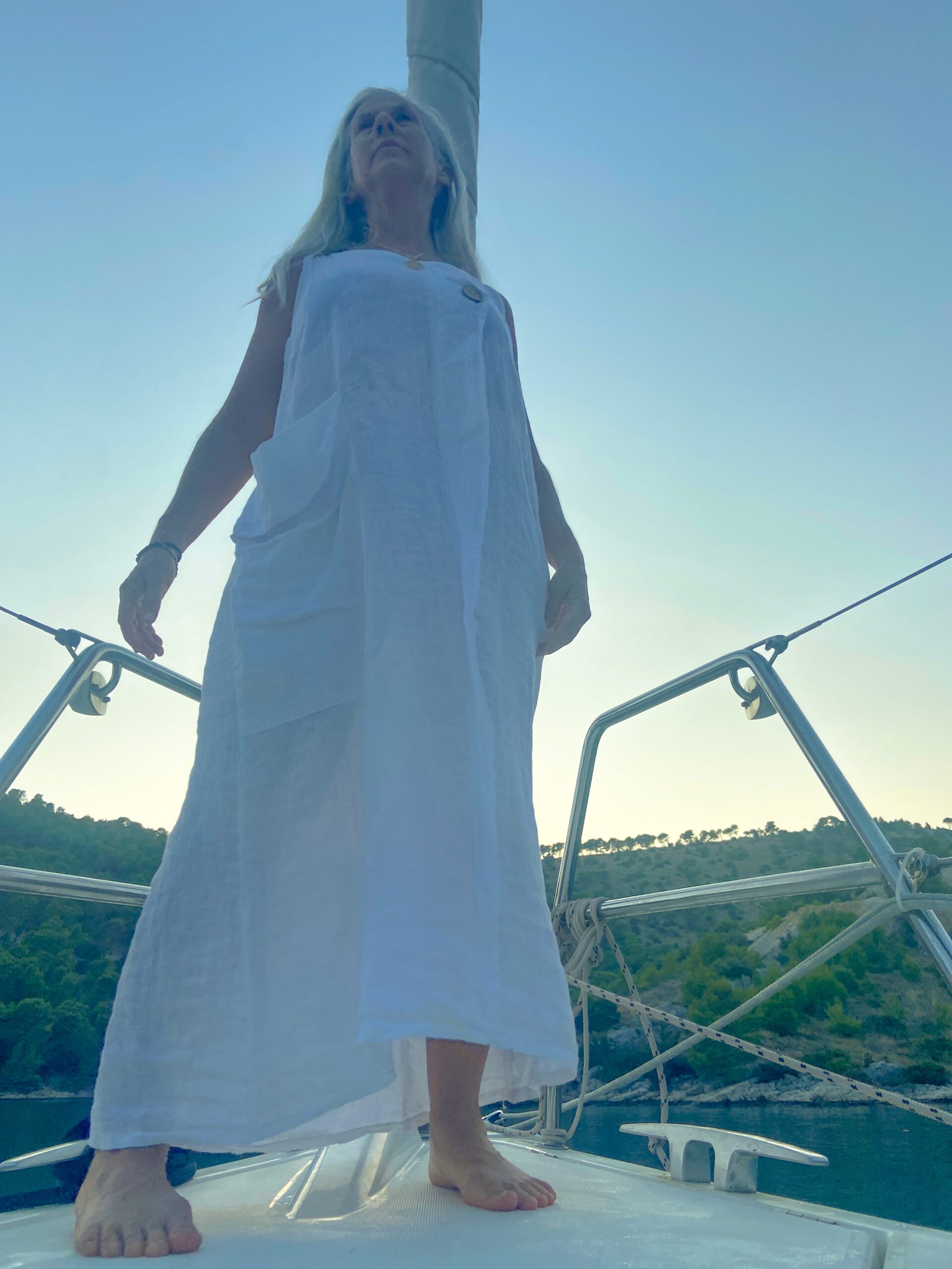 artist on sailboat in white dress